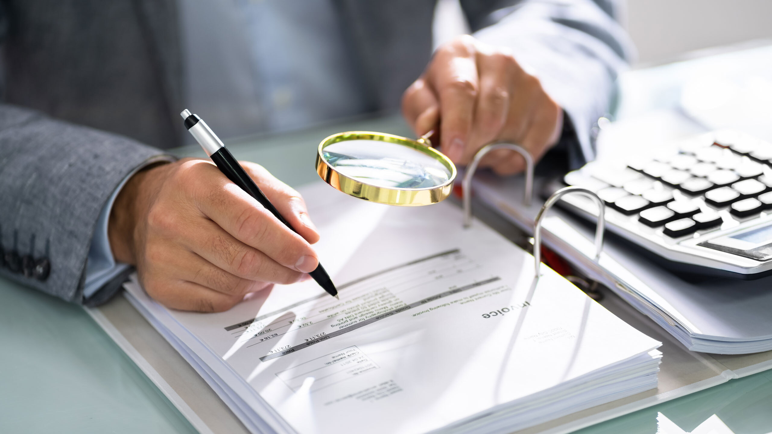 Legal professional examining tax documents to protect client rights during an investigation.